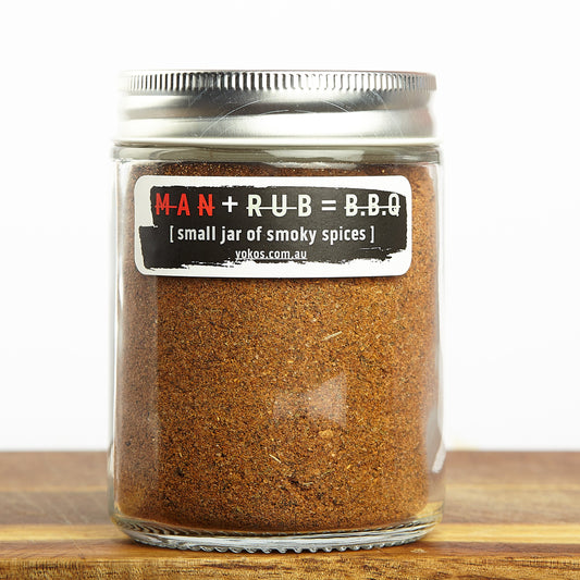 Jar of Byron Bay BBQ Man Rub on a wooden surface with a white background. Looks like impressive!