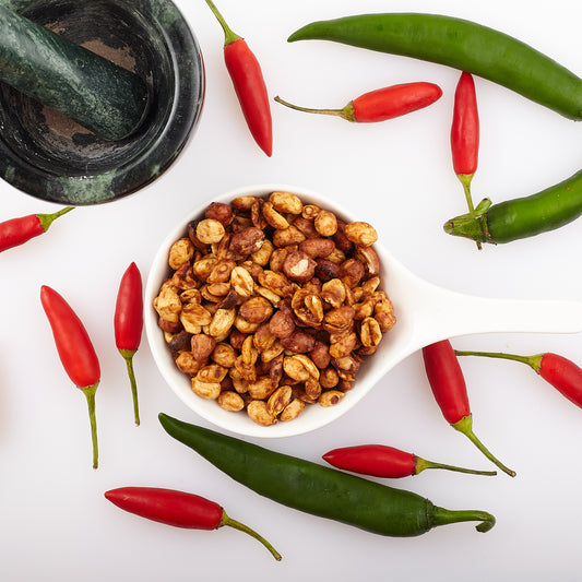 Bowl of Yoko's Byron Bay F.A.B nuts amonst birds eye chillis.