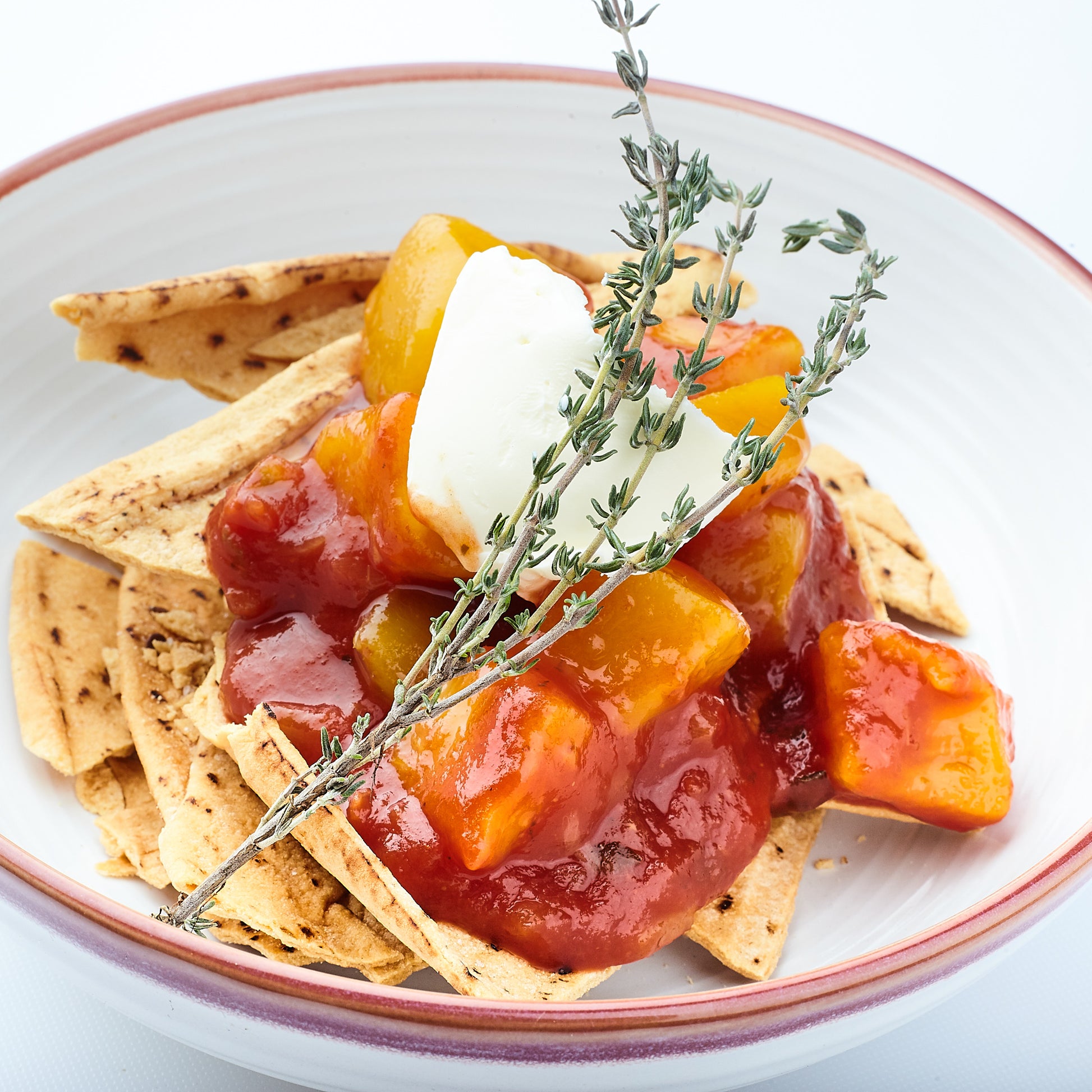 Toasted gluten free pita bread served with generous amounts of Yoko's Mango Tango Salsa. a dollop of vegan cream cheese and garnished with a spri9g of thyme.