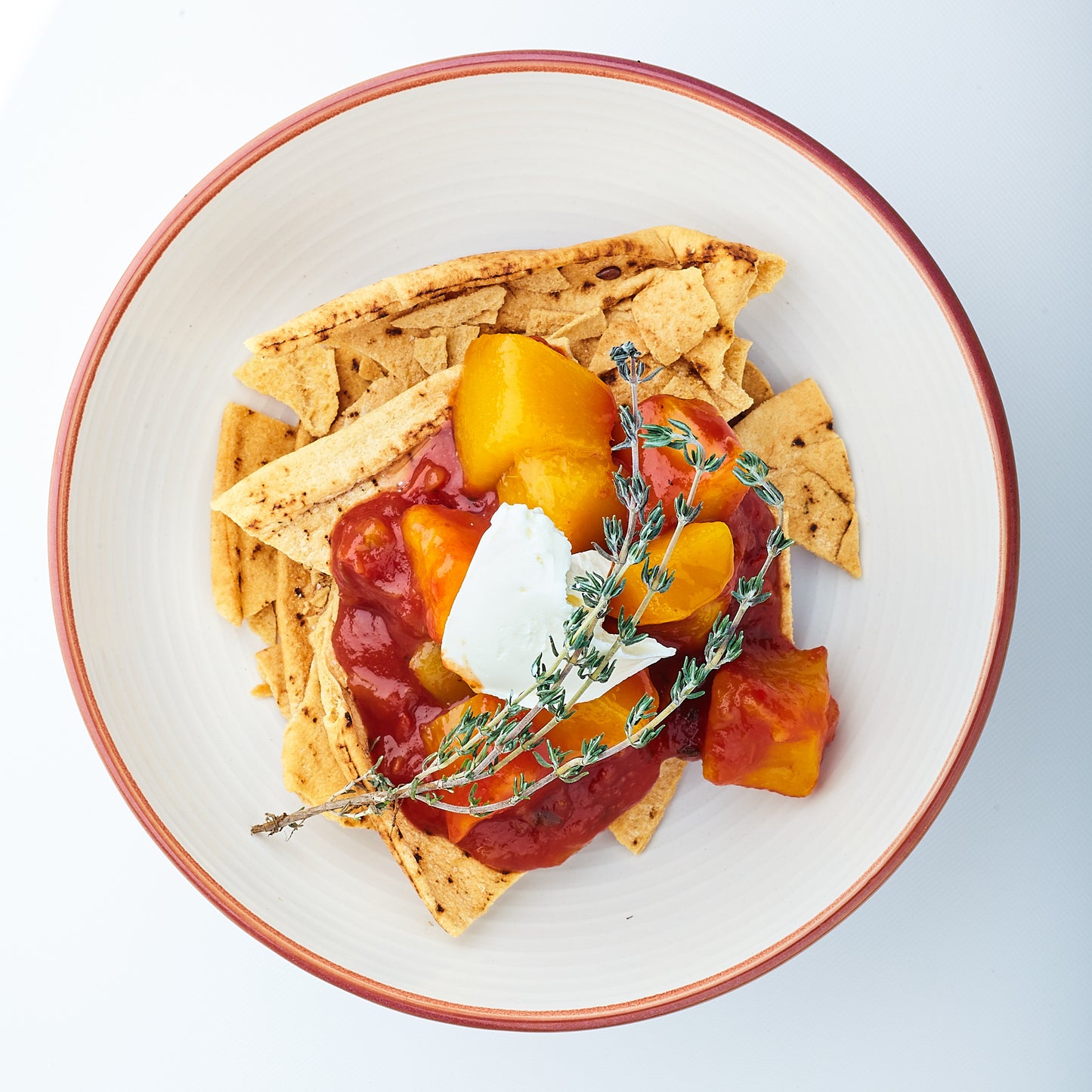 Toasted gluten free pita bread served with generous amounts of Yoko's Mango Tango Salsa. a dollop of vegan cream cheese and garnished with a spri9g of thyme.